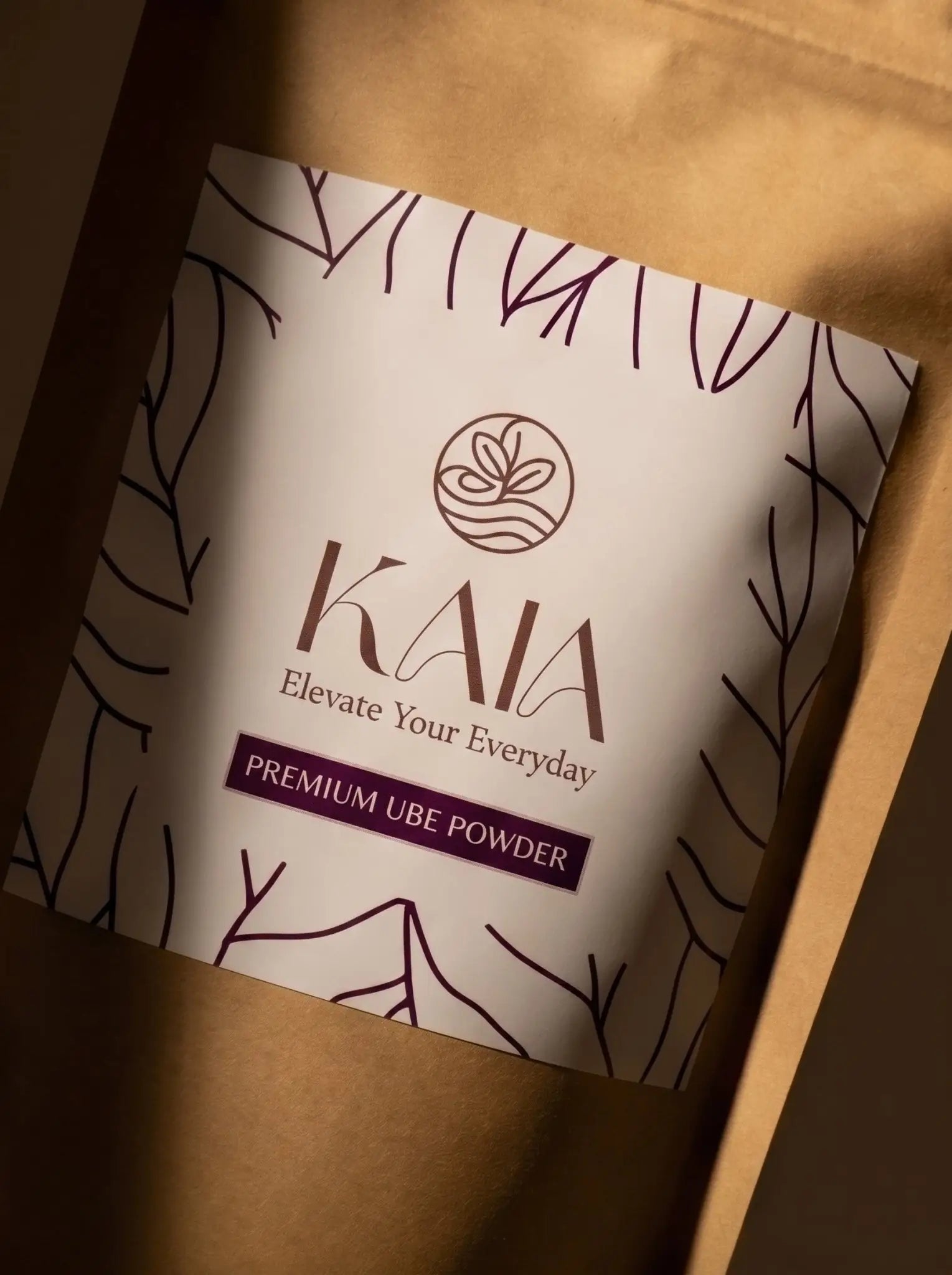 KAIA Origin premium ube powder 100g pouch on travertine pedestal, Belgian freeze-dried purple yam