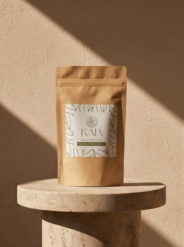 KAIA Origin premium matcha powder 80g pouch on travertine pedestal, Belgian stone-ground matcha